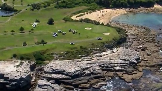 A man and child have died after being swept away from rocks while fishing at Little Bay. 