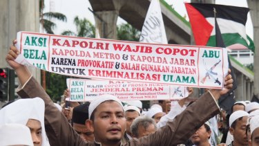 The Palestinian flag (seen here top right) is a common sight at mass protests in Jakarta.