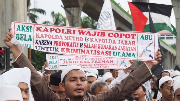 The Palestinian flag (seen here top right) is a common sight at mass protests in Jakarta.