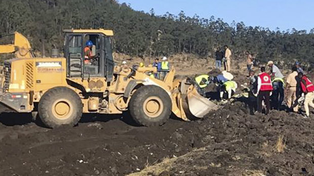 Rescuers use mechanical diggers at the site of an Ethiopian Airlines crash, south of Addis Ababa, in which 157 died.