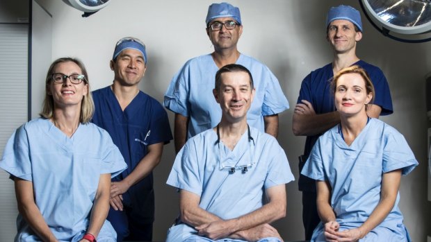 The saviours: (From left to right): Cardiothoracic surgeon Emily Granger, trauma surgeon on call Rohan Gett, urologist Raji Kooner   (behind), general and vascular surgeon Anthony Grabs (front) , anaesthetist Andrew Jackson (behind) and anaesthetist Romaa Steele (front).

