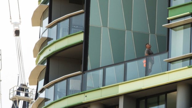Tradesmen work to fix the cracking at Opal Tower that caused residents to be evacuated twice in a week.
