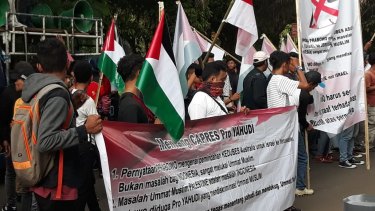 A small group outside the Australian embassy in Jakarta on November 30  holding Palestinian flags and protesting against Australia's consideration of  moving its embassy from Tel Aviv to Jerusalem.