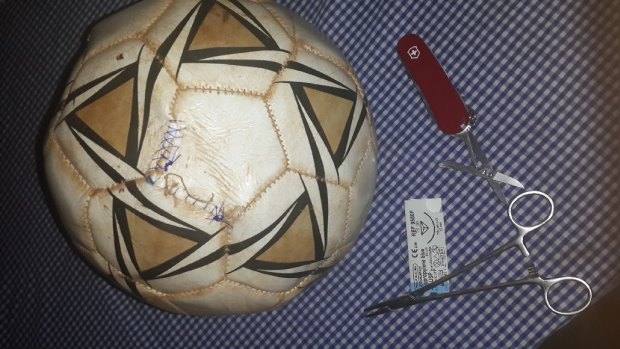 Red Cross worker Salah Raya sutured a soccer ball so young villagers, devastated by an oil tanker explosion, could continue their game.