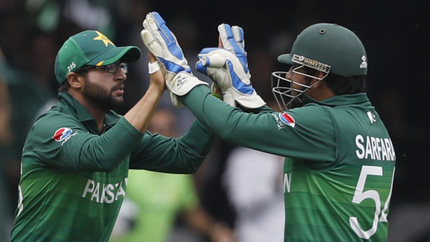 Pakistan's Imam-ul-Haq celebrates with captain Sarfaraz Ahmed after taking a catch to dismiss South Africa's Quinton de Kock at Lord's on Sunday.