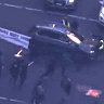 Car drives into protest by climate activist group in Sydney CBD