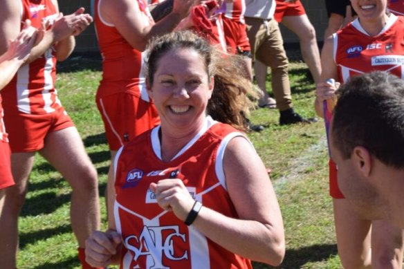 Nadene McBride running onto the football field.