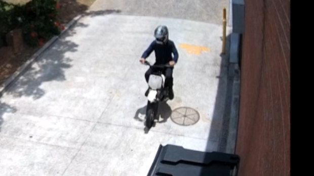CCTV footage showed a man in a helmet riding a bike around the hairdresser. 