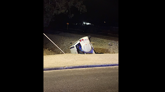A Suzuki Grand Vitara crashed into an embankment and rolled over after narrowly avoiding a freight train in Midvale.