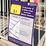 The parking hub and a sign explaining the $1 trip fee for e-scooters and e-bikes.