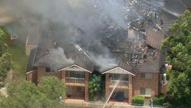 An apartment complex in Bass Hill has caught fire and the roof has collapsed.