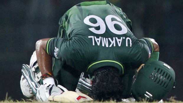Umar Akmal kisses the turf after Pakistan won the game.