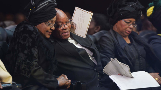 Winnie Madikizela-Mandela hugs South African President Jacob Zuma following his speech during the funeral service for Nelson Mandela.