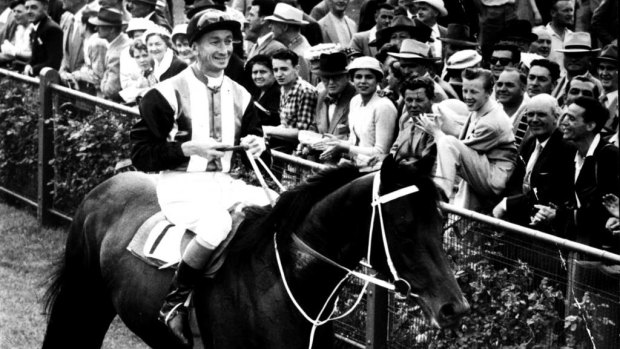 Champion: Tulloch returns to scale with  George Moore after winning the 1957 Victoria Derby at Flemington.