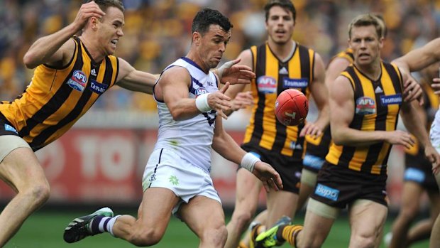 Fremantle's Ryan Crowley is chased by Hawthorn's Max Bailey.