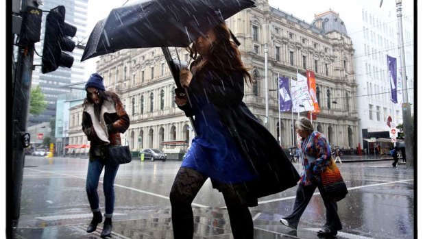 Rain and wind batter Melbourne as shoppers try to take cover on Elizabeth Street.