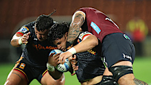 Wallace Sititi of the Chiefs is tackled to the ground.