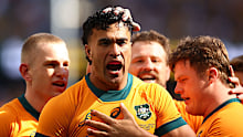 Joseph-Aukuso Suaalii of the Wallabies celebrates with teammates after scoring a try.