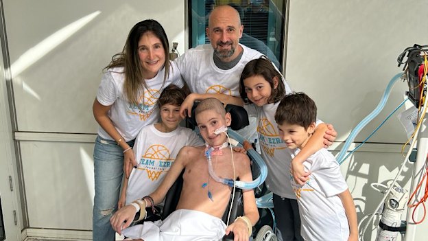 Ezra in hospital surrounded by his family (from left) mum Natasha, brother Alon, dad Dean and brothers Levi and Eden.