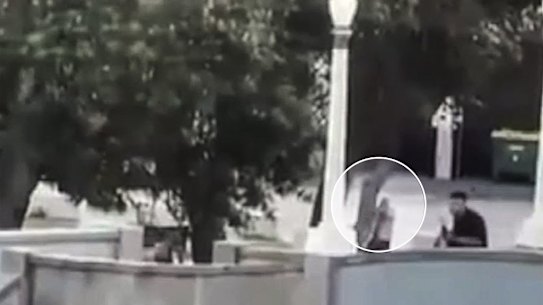 Police officer takes shots towards the gunmen