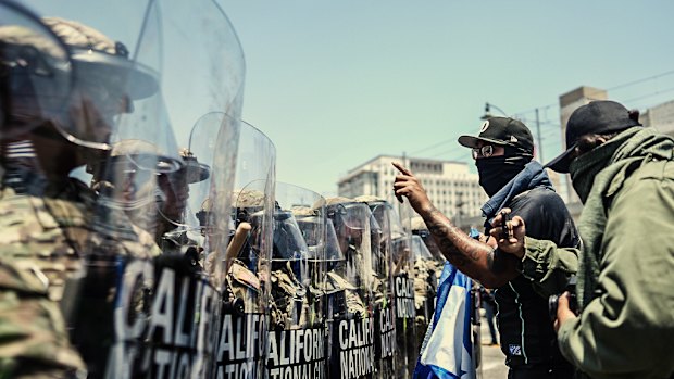 Protesters confront a line of the California National Guard in downtown Los Angeles on Sunday.