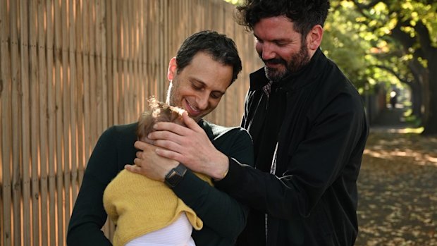Simon Abrahams and his partner Hamish with their four-month-old daughter who was born through surrogacy.