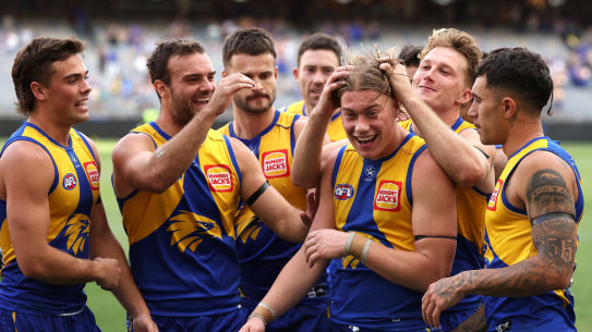 Teammates surround Harley Reid after their win against Richmond at Optus Stadium. 
