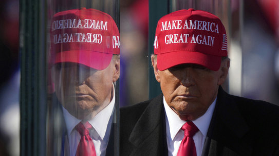  President-elect Donald Trump is reflected in  bullet-proof glass at  a campaign rally on November 3.