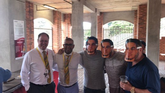 Cricket South Africa officials Clive Eksteen and Altaaf Kazi pose with spectators wearing Sonny Bill Williams masks at St George’s Park in 2018.