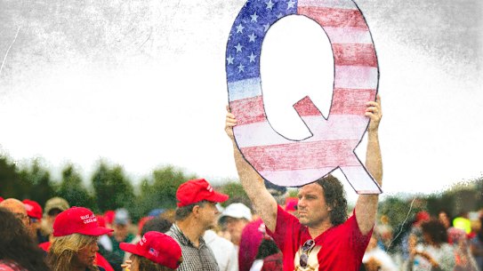 FILE - In this Aug. 2, 2018, file photo, David Reinert holding a Q sign waits in line with others to enter a campaign rally with President Donald Trump in Wilkes-Barre, Pa. A far-right conspiracy theory forged in a dark corner of the internet is creeping into the mainstream political arena. It's called QAnon, and it centers on the baseless belief that President Donald Trump is waging a secret campaign against enemies in the “deep state.”  (AP Photo/Matt Rourke, File) Q anon. modified Getty image