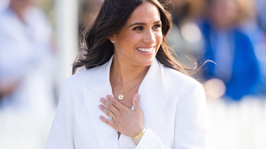 Meghan loves to play against type, pictured here, mixing a piece of hand jewellery from Catbird with a Cartier watch from Princess Diana.