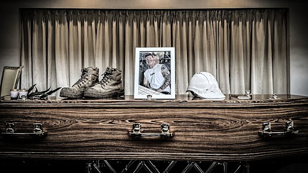 Ben Nash’s work gear rests atop his coffin. 
