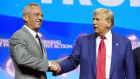 Republican presidential nominee former President Donald Trump shakes hands with Robert F. Kennedy Jr.