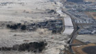 Earthquake-triggered tsumanis sweep shores along Iwanuma in northern Japan. 