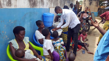 People attend a coronavirus information session led by a local foundation in Uvira, South Kivu Province.