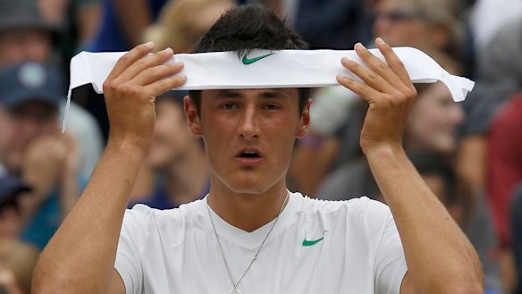 Bernard Tomic of Australia puts on his headband during his quarter-final match against Novak Djokovic of Serbia at the 2011 Wimbledon tennis championships.