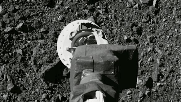 The sampling arm of the OSIRIS-REx spacecraft during a rehearsal for an approach to the "Nightingale" sample site on the surface of the asteroid Bennu. 