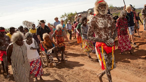 In 2011, East Arnhem land chief law man Jacob Nayinggul is pushed in his wheelchair by ANU historian Martin Thomas as he supervises proceedings as human remains are finally returned to their ancestral home in Gunbalanya, in Arnham Land. 