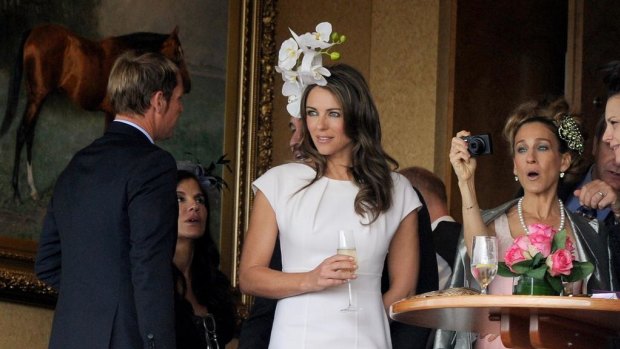 Sarah Jessica Parker takes a picture of Liz Hurley with Shane Warne in the chairman's private box during Oaks Day at Flemington.