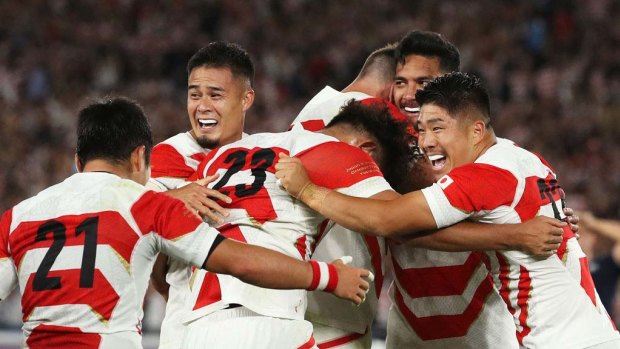 Japan's players celebrate after beating Scotland to progress to the Rugby World Cup quarter-finals.