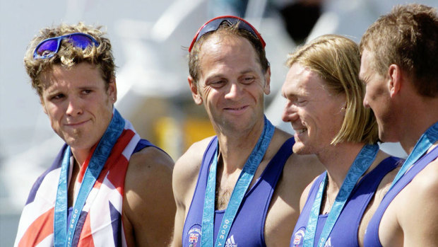 Britons Matthew Pinsent, Tim Foster, Steven Redgrave and James Cracknell (R to L) smile on the podium after winning the gold medal in the men's coxless fours.