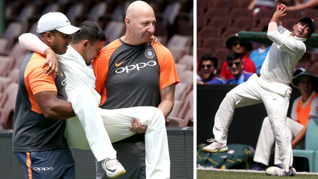 India's Prithvi Shaw is taken from the field after badly rolling his ankle (right).