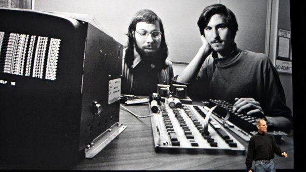 Steve Jobs talks in front of a picture of himself and Apple co-founder Steve Wozniak from 1977.