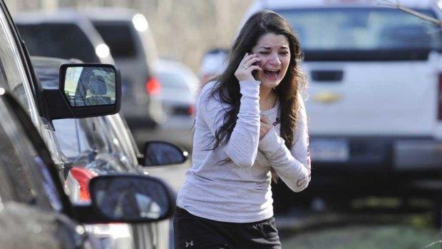 A woman waits to hear about her sister, a teacher, following a shooting at the Sandy Hook Elementary School in 2012.