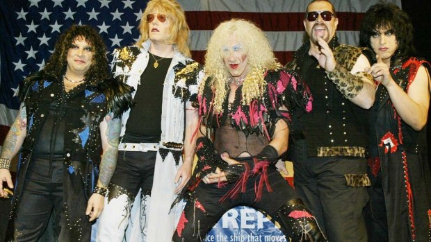 Members of the reunited metal band Twisted Sister, including Dee Snider (centre), pose for photos before a press conference in New York on April 29, 2003.