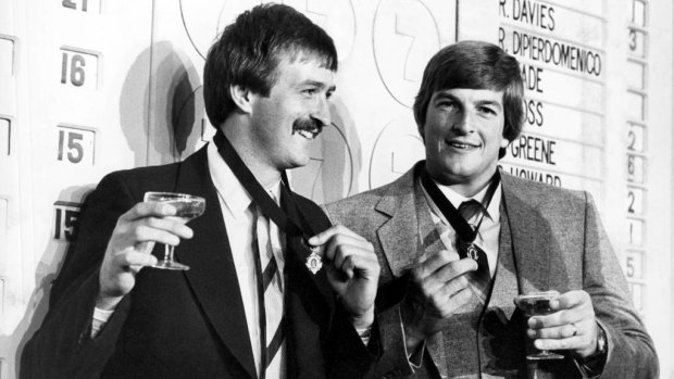 Bernie Quinlan (Fitzroy) and Barry Round, captain of South Melbourne, toast their Brownlow Medal win in 1981 .