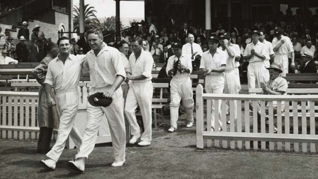 Fond farewell: Alan Davidson and Neil Harvey, playing in their final Tests, lead Australia onto the SCG during the 1962-63 Ashes.