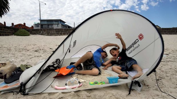 A beach tent blows over on Middle Park beach. 