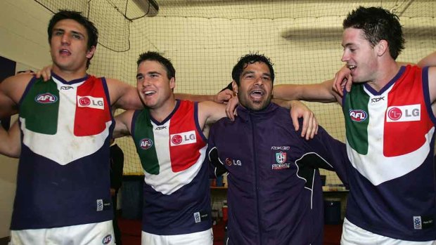 Matthew Pavlich, Paul Haselby, Jeff Farmer and Steven Dodd sing the club song after round 15 against Collingwood at the MCG, July 16, 2006.