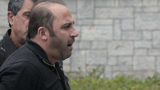Tony Mokbel arrives at Athens' Korydallos prison in May 2008 before being flown back to Australia.